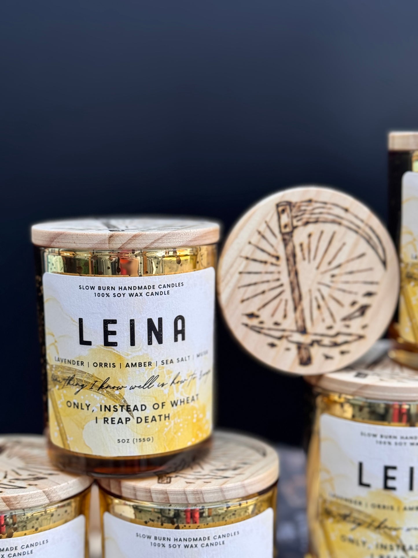 LEINA candle with wooden lid and label on a dark background