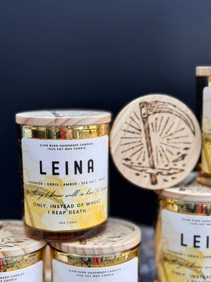 LEINA candle with wooden lid and label on a dark background